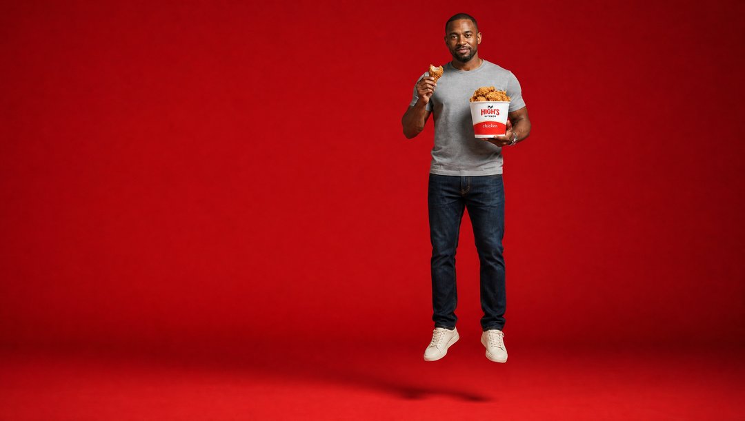 Hero talent lifting off the floor holding a High's bucket on a red void